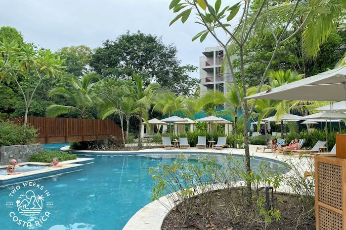 Pretty pool with hotel and trees in background