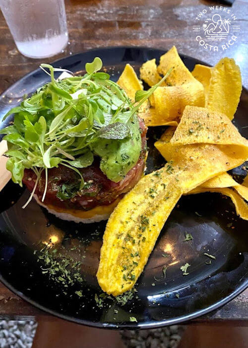 plantain chip alongside tuna tartare with greens