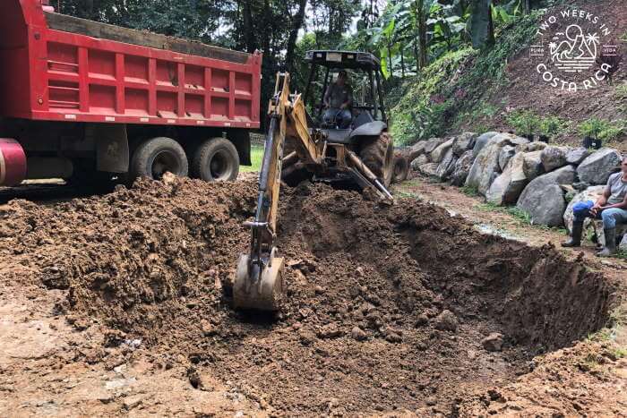 Backhoe digging hole for pool