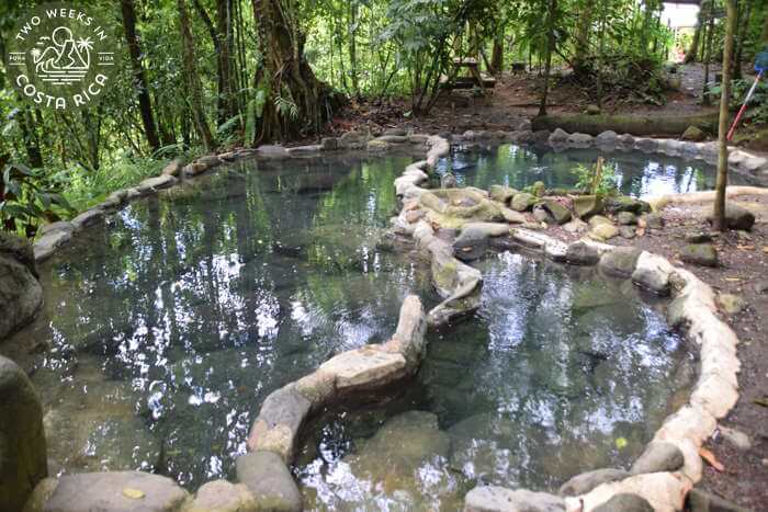 shallow thermal hot spring pools bordered by rocks