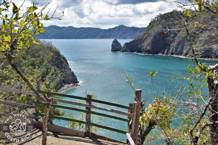 Looking down at shallow blue water from a viewpoint