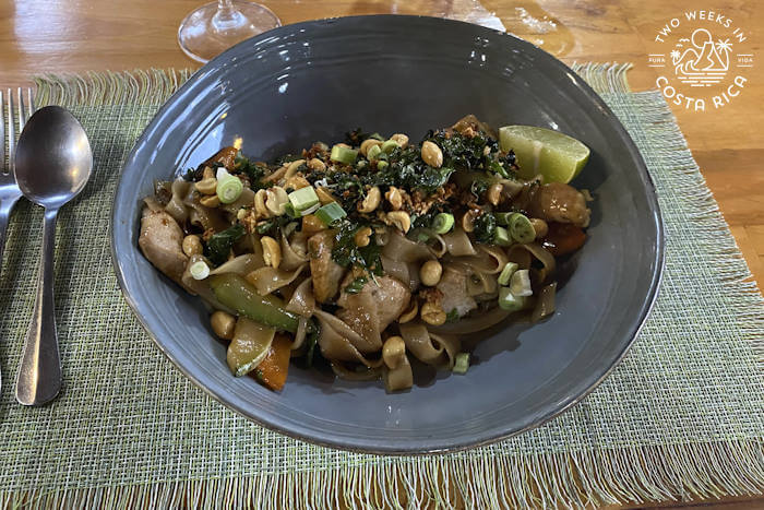 noodle dish with garnishes in blue bowl 