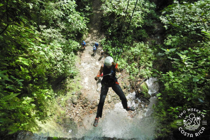 rappelling down tall waterfall arenal area