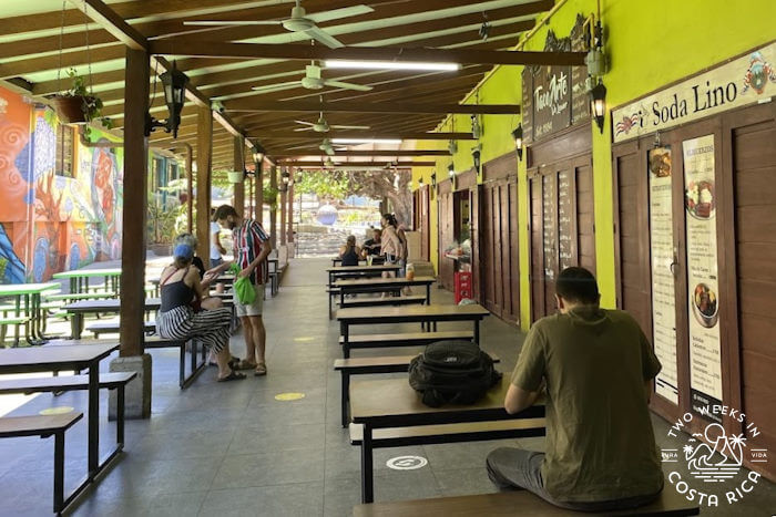 Row of tables in front of Ciudad's historic buildings