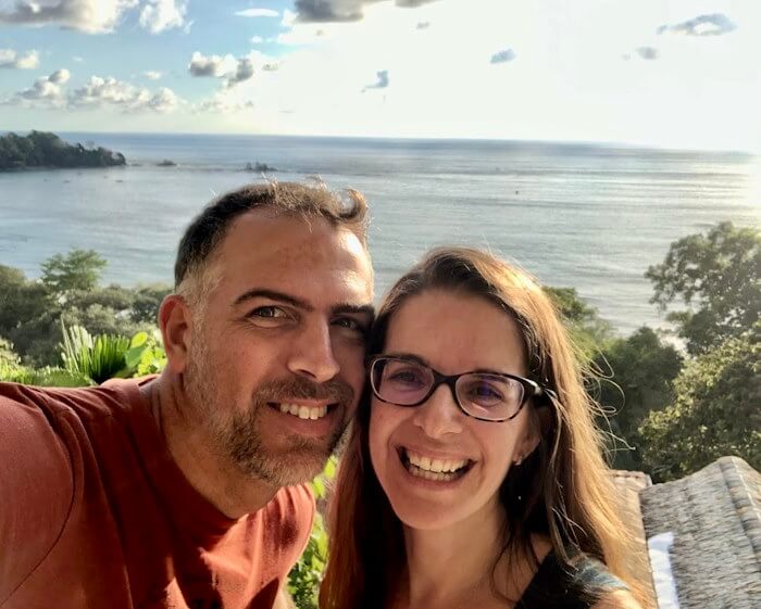 couple with ocean and rainforest in background