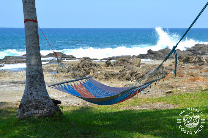 colorful hammock with waves crashing in background